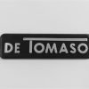 DT545 Targhetta DE TOMASO, plastica, mm.85x23, con biadesivo a tergo