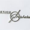 MI2 Scritta DESIGN G. MICHELOTTI cromata, lunghezza mm.90, con 2 perni a tergo