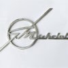 MI9 Scritta G. MICHELOTTI cromata, lunghezza mm.100, con 2 perni a tergo
